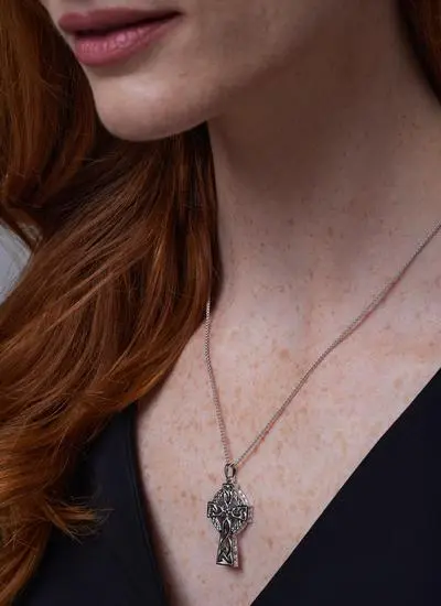 Close up side angle shot of red haired woman wearing Sterling Silver Traditional Large Celtic Cross Pendant